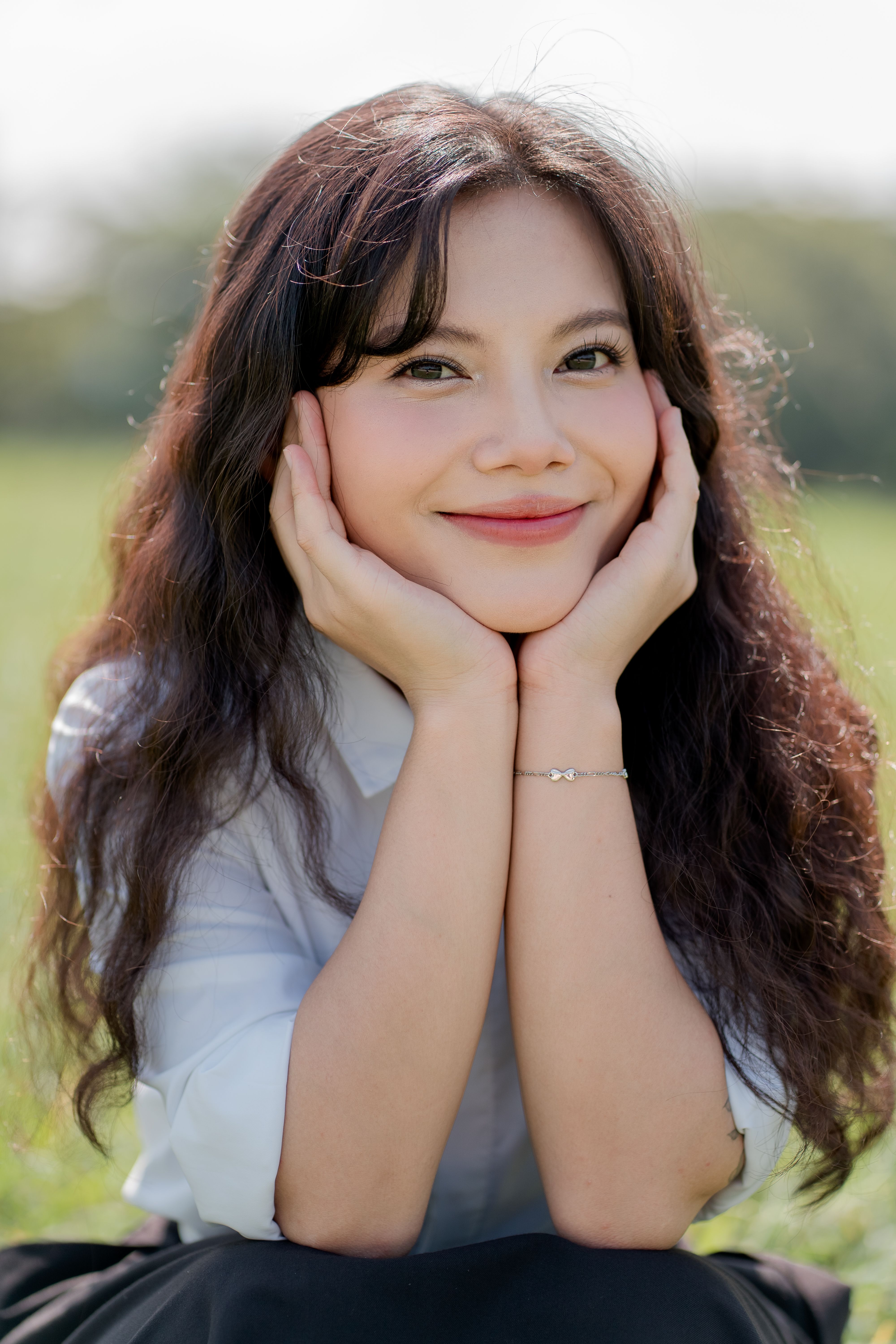 Smiling Woman Relaxing Outdoors in Nature · Free Stock Photo