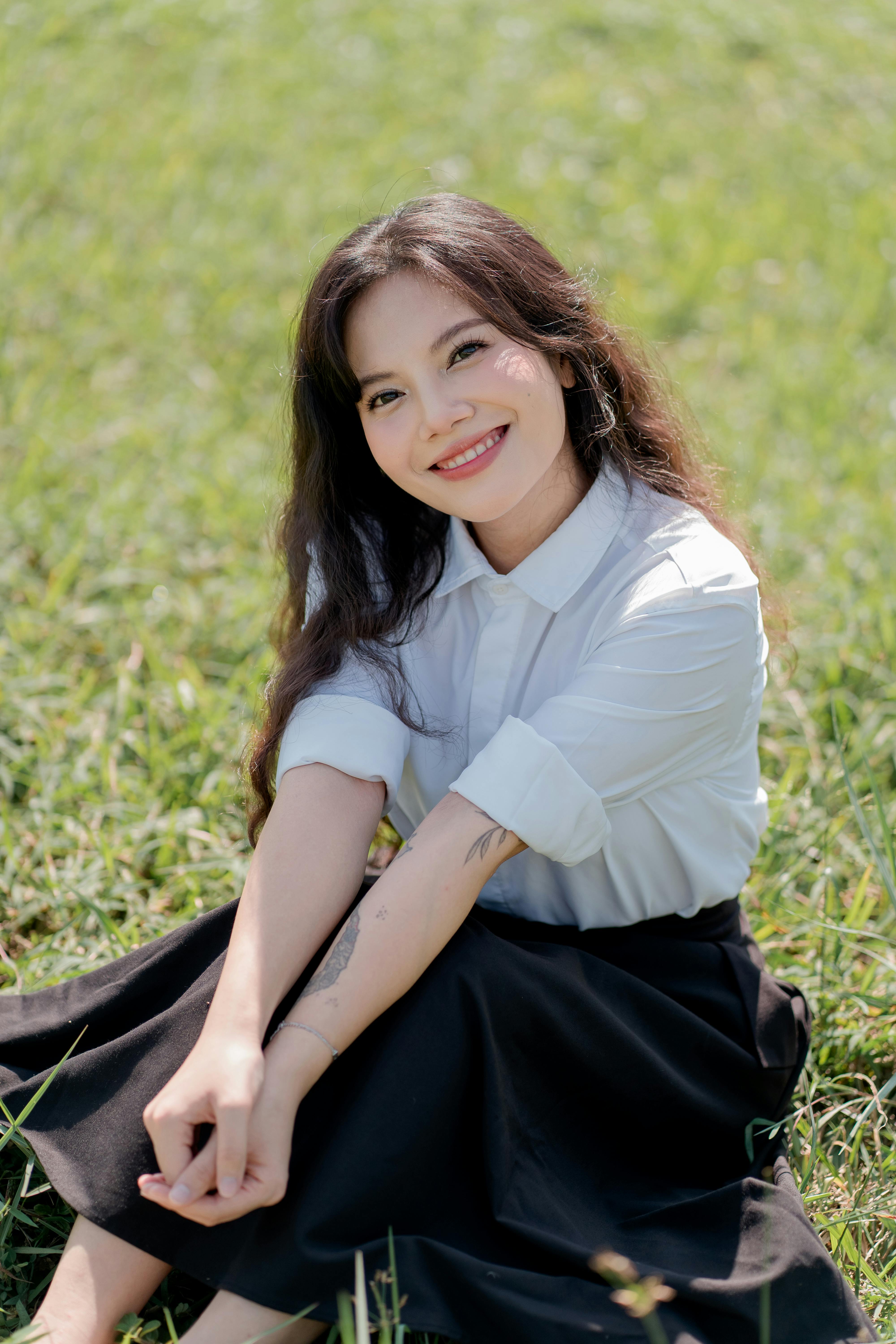 smiling woman relaxing in sunny park setting