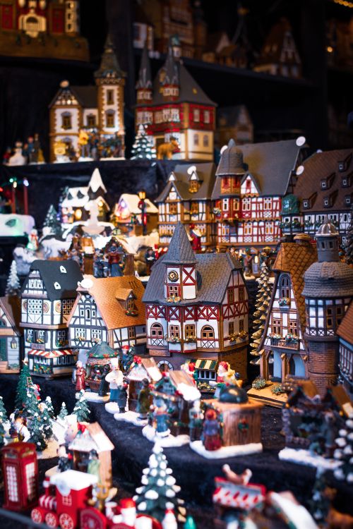 Free Detailed miniature Christmas village with festive decorations and cozy buildings. Stock Photo