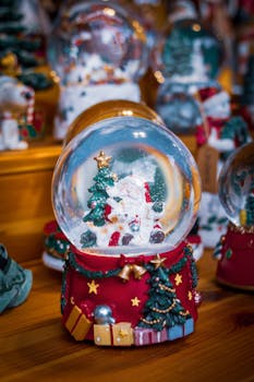 Colorful snow globe with Christmas theme, perfect for holiday decoration.