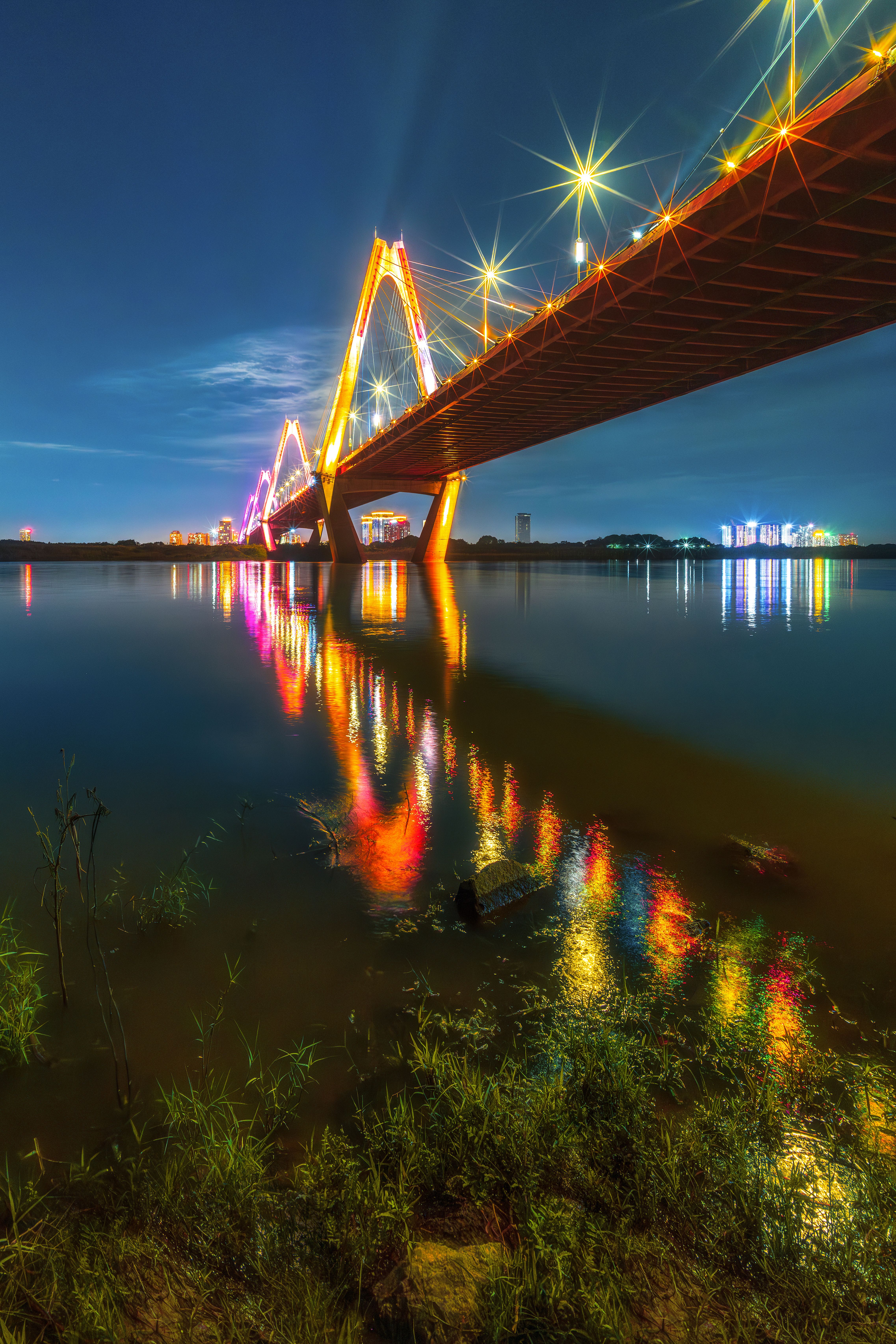 Night View of Illuminated Bridge Over River · Free Stock Photo