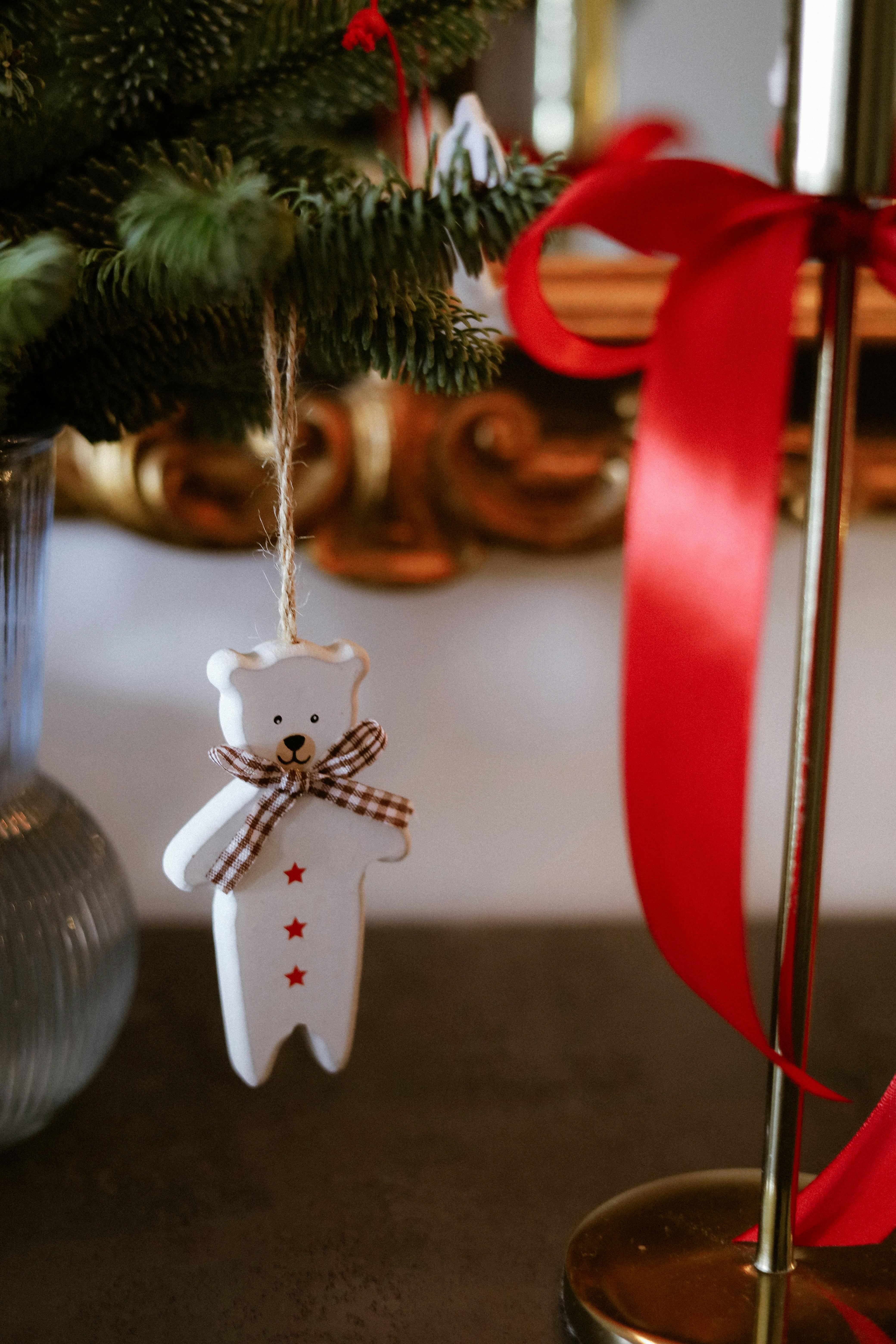 Charming white bear ornament with red stars, perfect for Christmas decor.