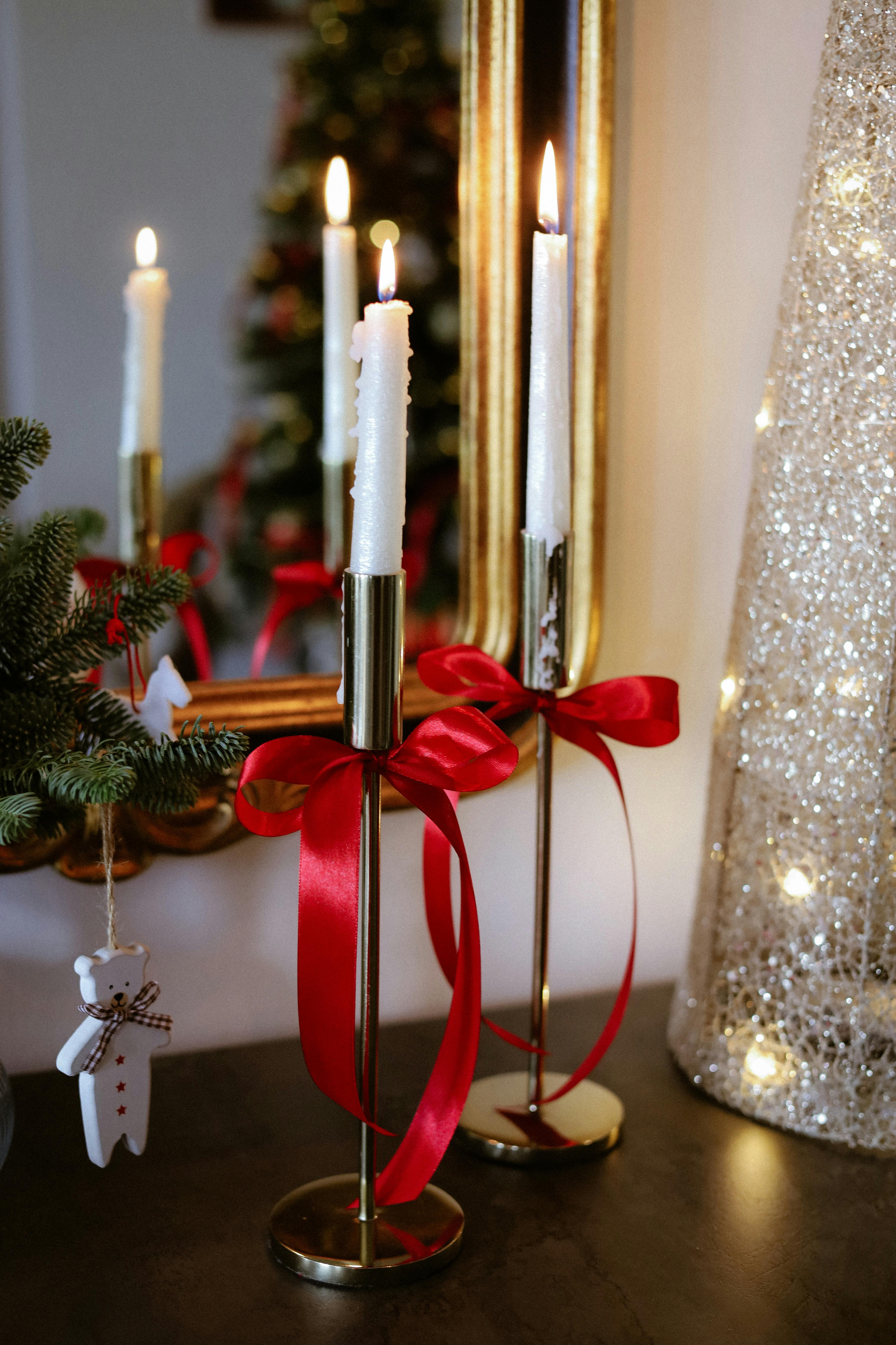 elegant christmas candle setup with red ribbons