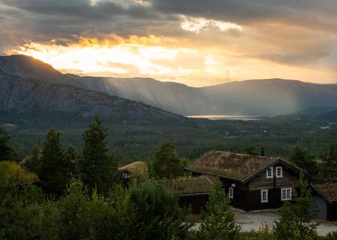 Idyllic sunset over a Norwegian lake and mountainscape, capturing serene natural beauty.
