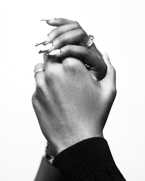 Free A black and white photograph showcasing two clasped hands symbolizing unity. Stock Photo