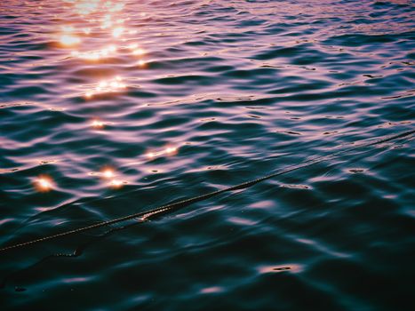 Sunset sparkles reflecting on water surface in Stockholm, creating a cinematic and peaceful ambiance.