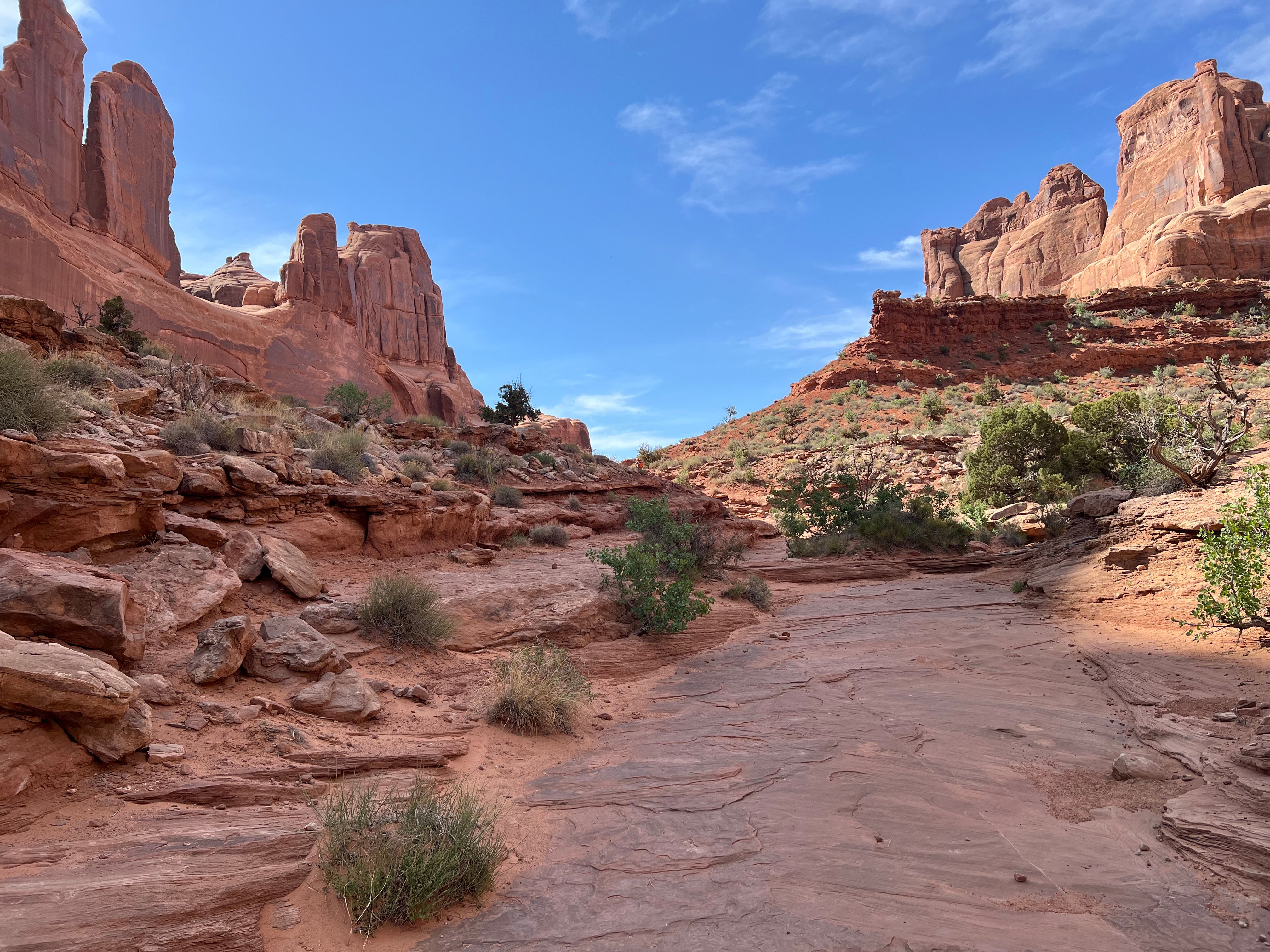 Hikers in the narrow Joint Trail slot in the Needles