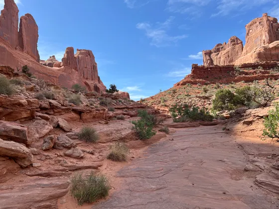 Hikers in the narrow Joint Trail slot in the Needles