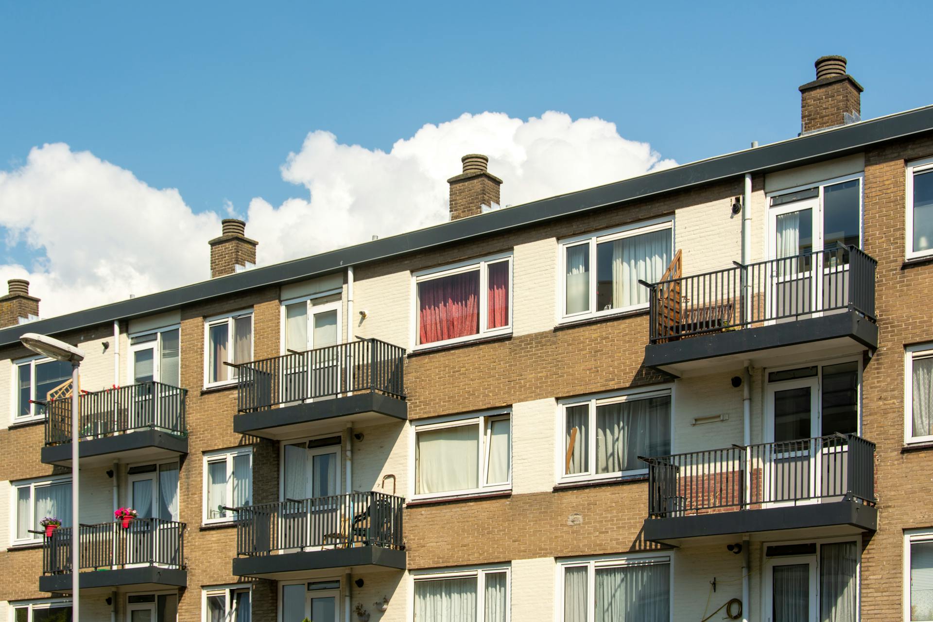 A sunny view of a modern apartment building facade in Voorburg, Netherlands.