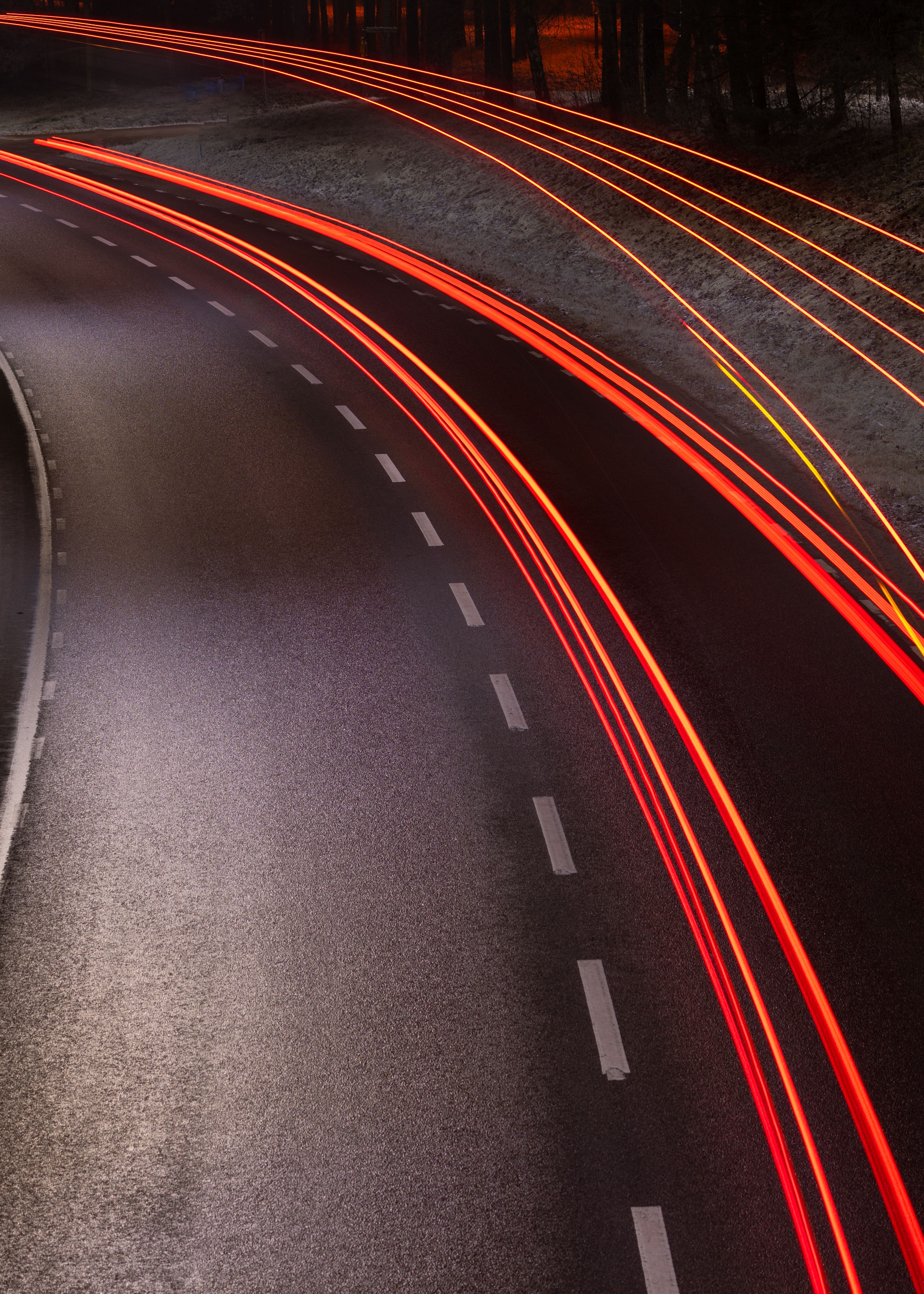Captivating long exposure image showcasing car light trails on a highway at night, conveying motion.