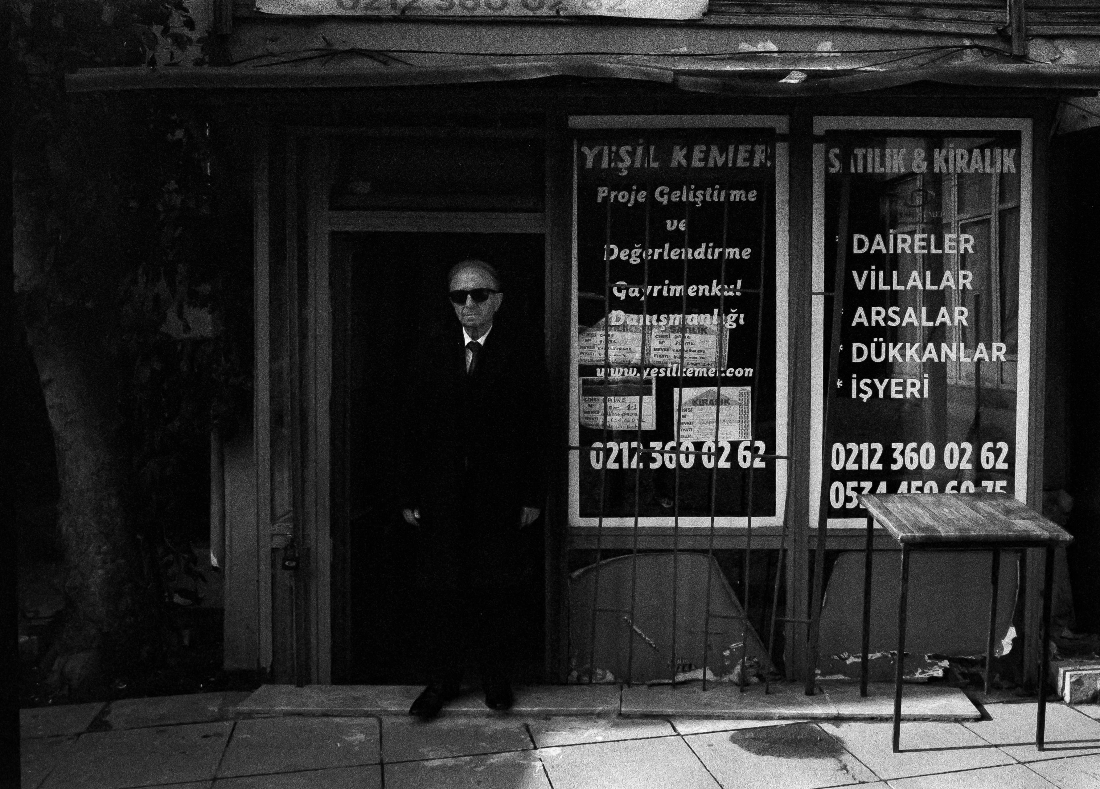 mysterious man black suit sunglasses shadows