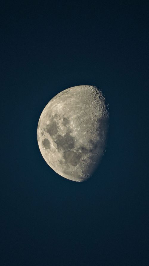 Free Detailed shot of the waxing gibbous moon with visible craters and shadow contrast against a dark sky. Stock Photo