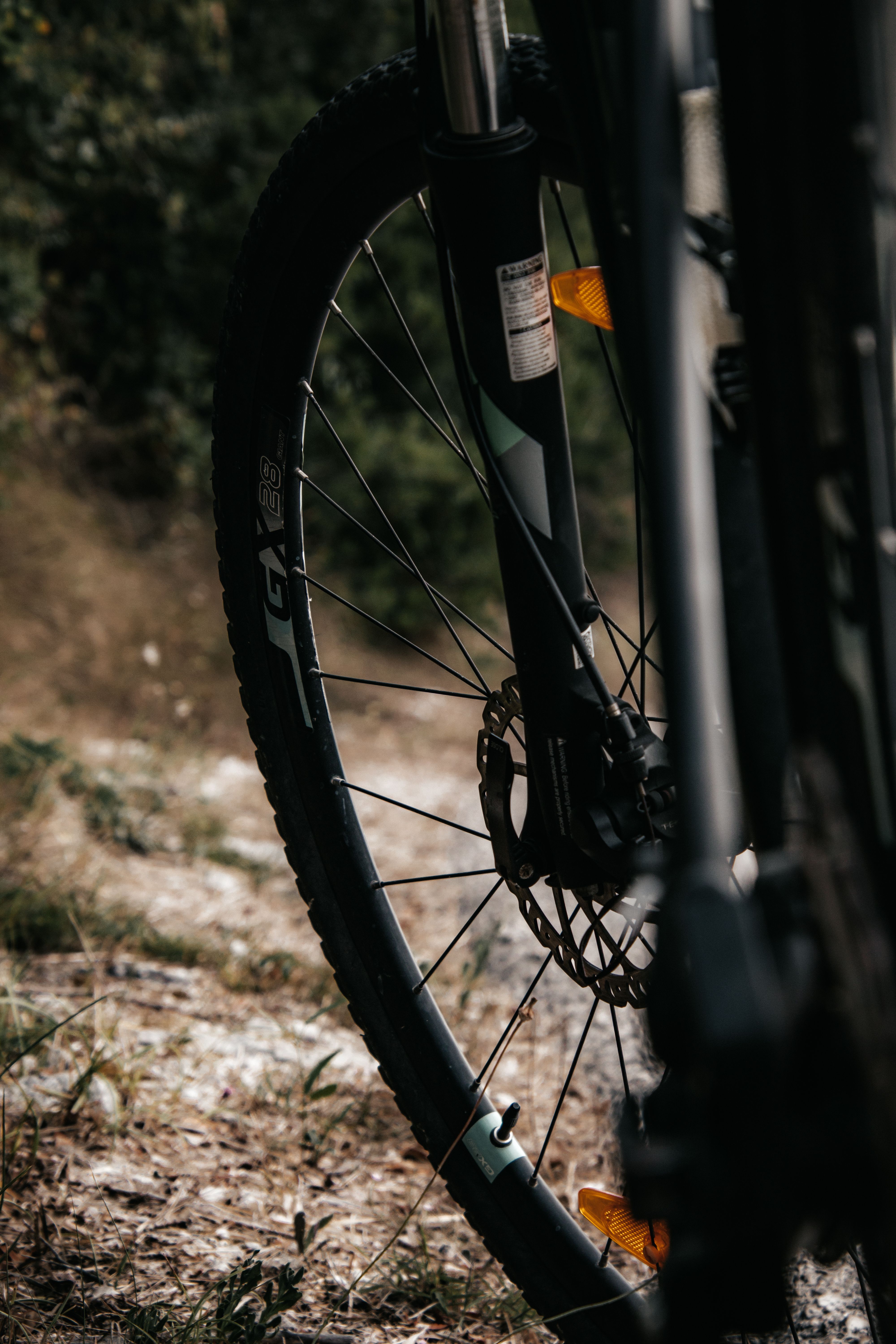 Close-up of a bicycle wheel on a rustic trail in Croatia, capturing an adventurous mood.