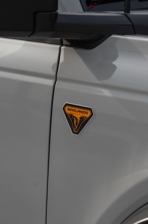 Free Close-up shot of the Ford Bronco Badlands edition emblem on the car's door, highlighting its rugged branding. Stock Photo