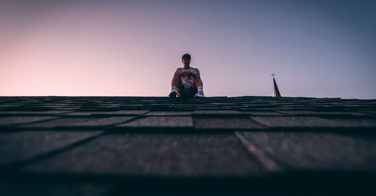 Man Sitting On Roof · Free Stock Photo