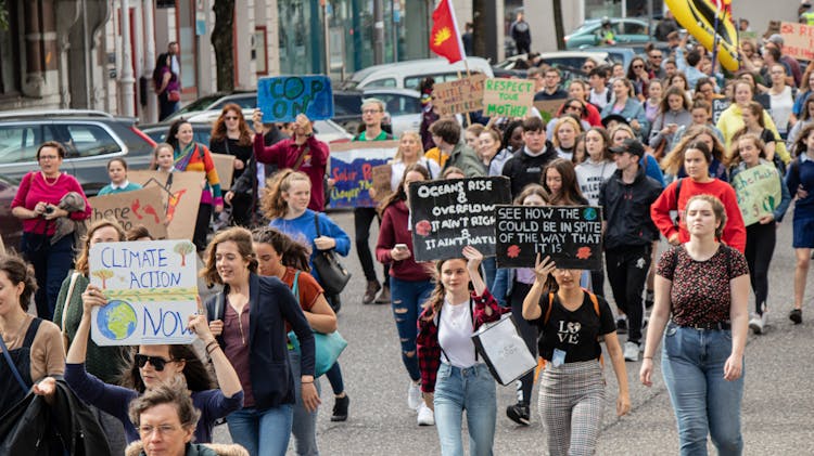 Crowd Of People Marching On A Rally