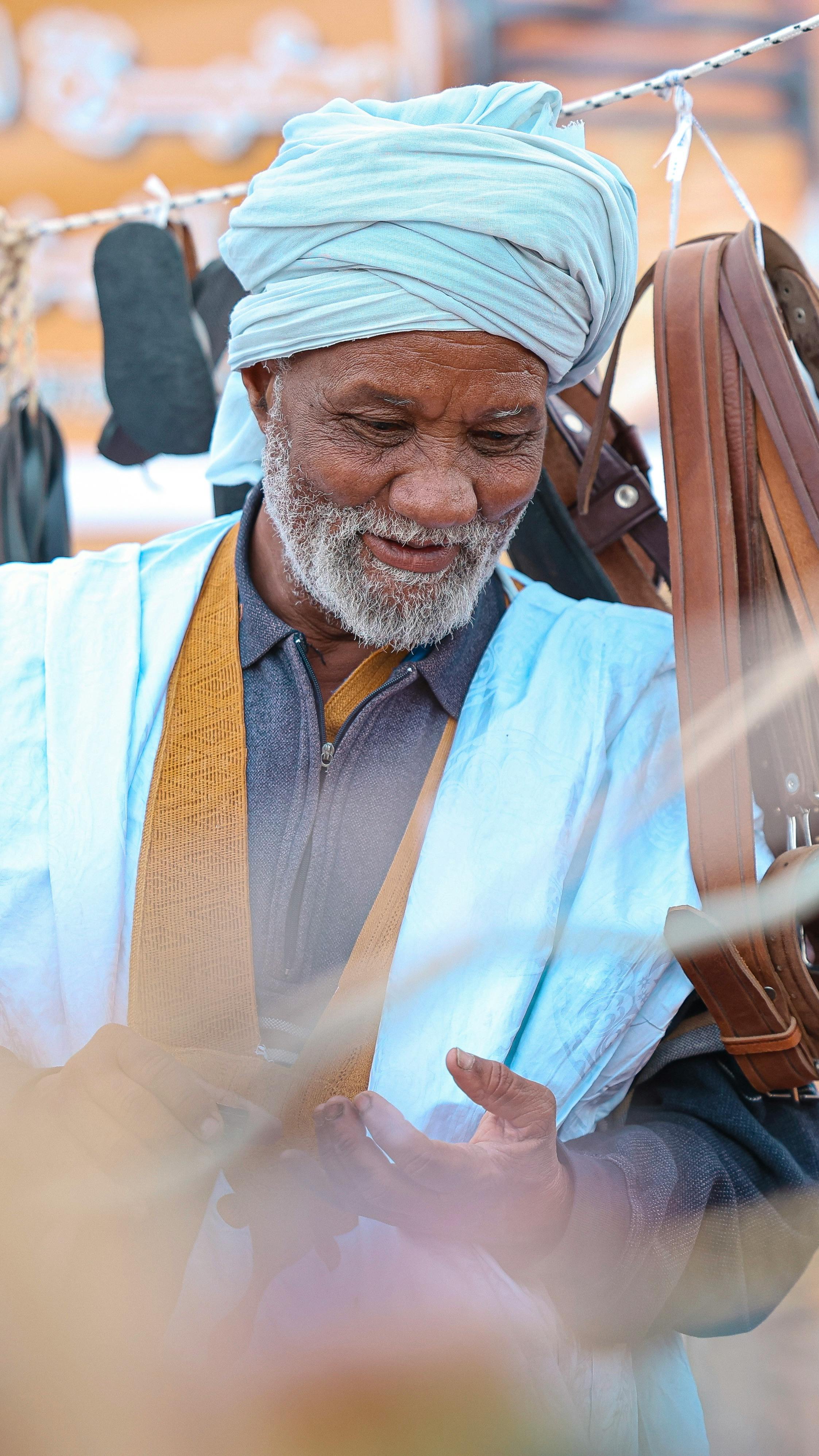 elderly man in traditional attire at market