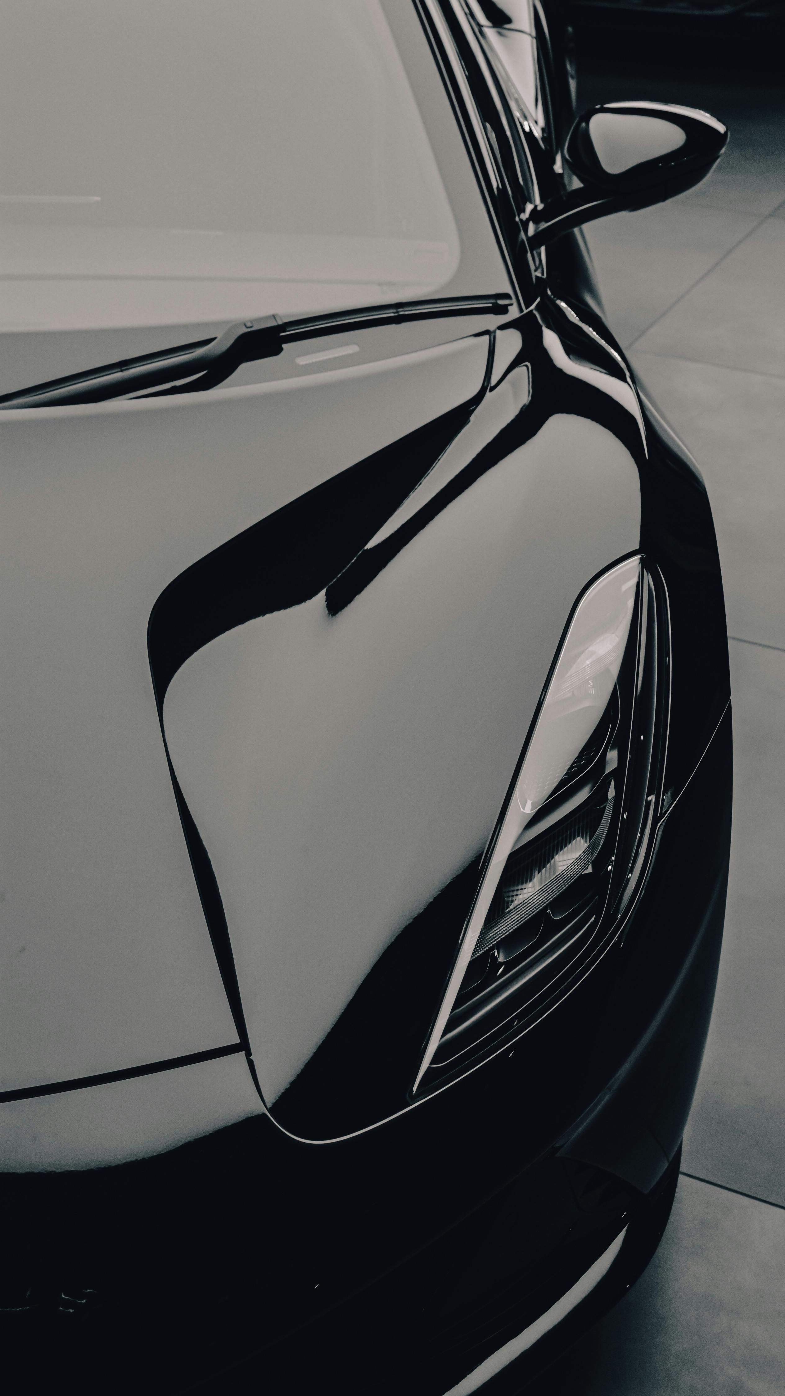 免費 黑色跑車時尚、現代的車頭燈設計的特寫。 圖庫相片