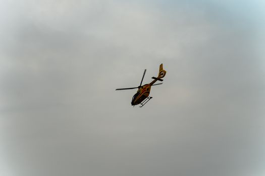 Aerial view of a helicopter flying over a cloudy sky in Brzegi, Małopolska, Poland.