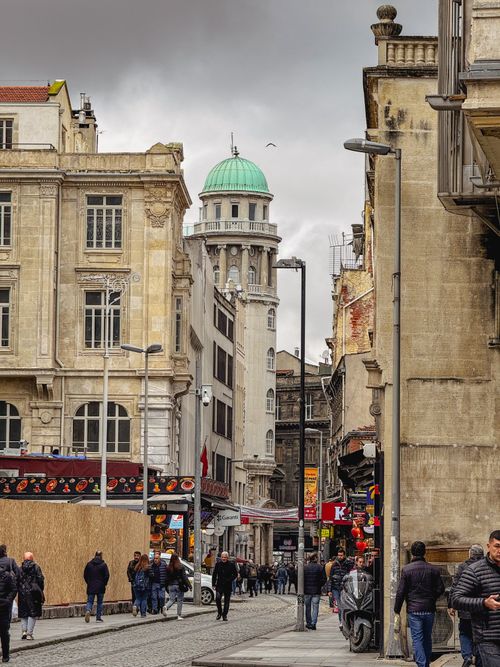 Free Bustling street scene features historical buildings and busy pedestrians. Stock Photo