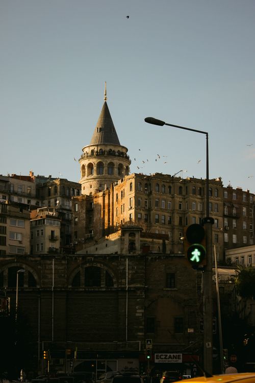 Free View of the historic Galata Tower amidst Istanbul's urban landscape at dusk. Stock Photo