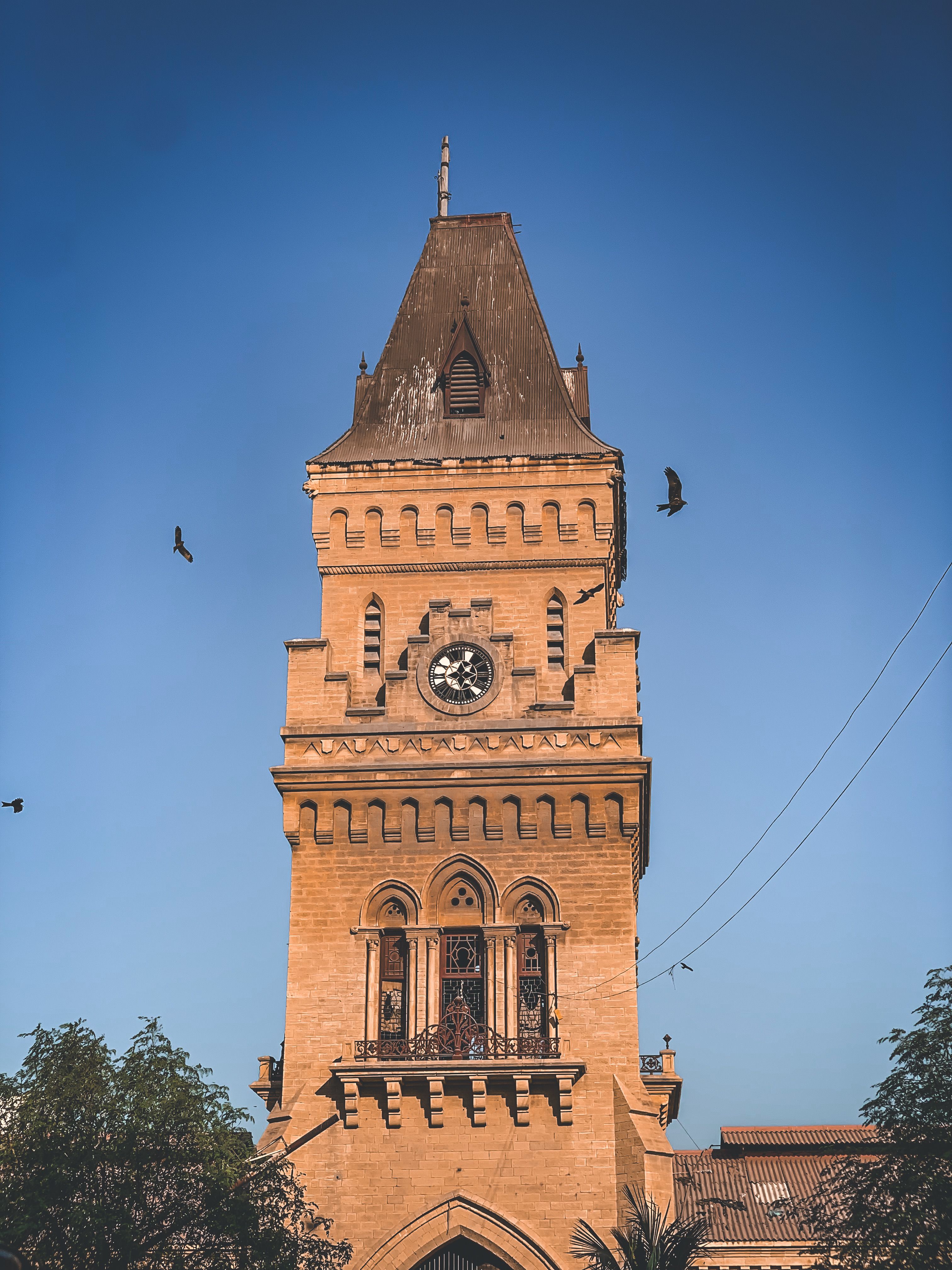 Historic Clock Tower Against Clear Blue Sky · Free Stock Photo