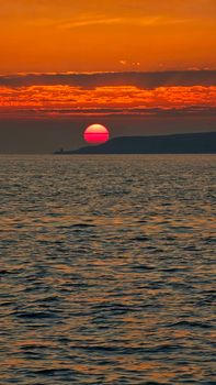Captivating image of a vibrant sunset over the ocean reflecting warm hues.