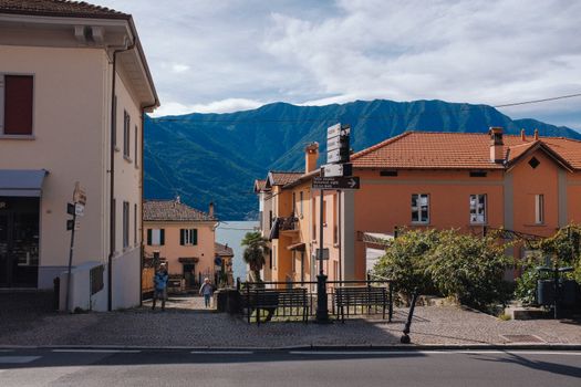 Picturesque street view of a charming village with mountains in the background.