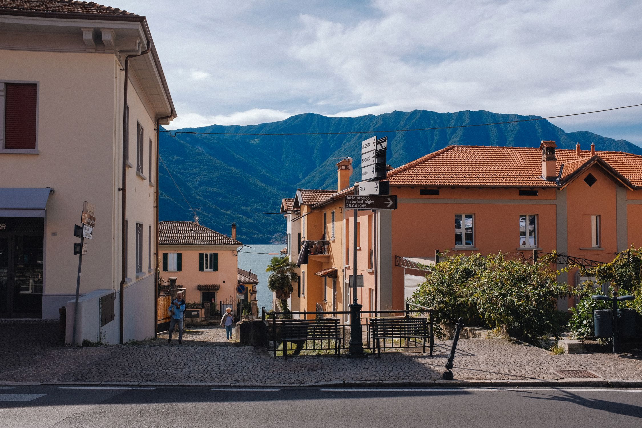 Picturesque street view of a charming village with mountains in the background.
