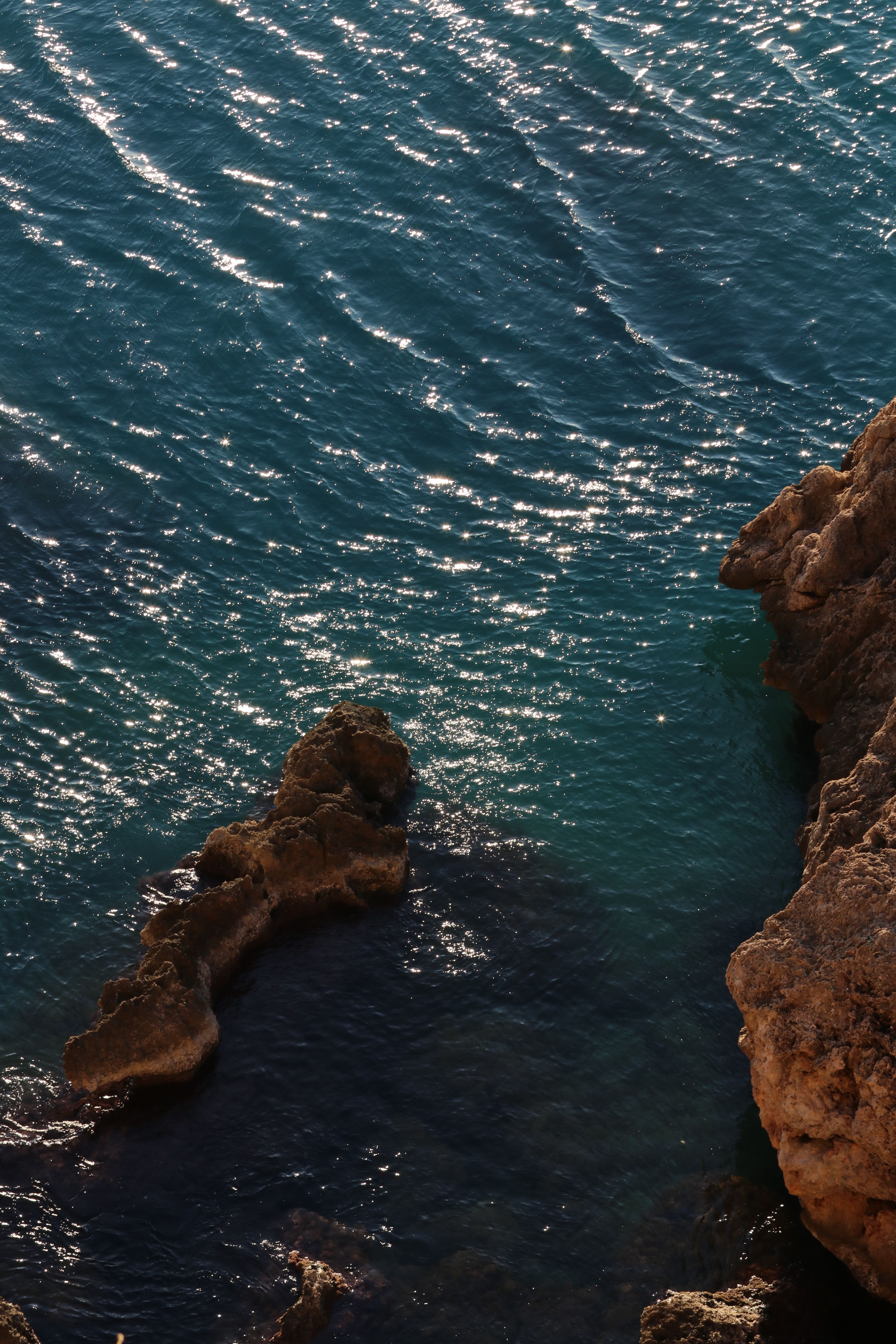 Clear Blue Water and Rocky Coastline · Free Stock Photo
