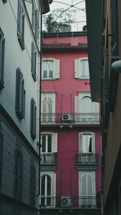 Pimk Color Building Vibrant Pink Building Between Narrow Alleys · Free Stock Photo