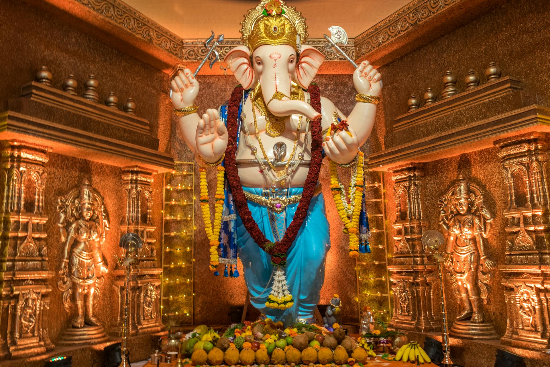 Vibrant Ganesh idol adorned for Ganesh Chaturthi festival in Mumbai temple, showcasing cultural traditions.