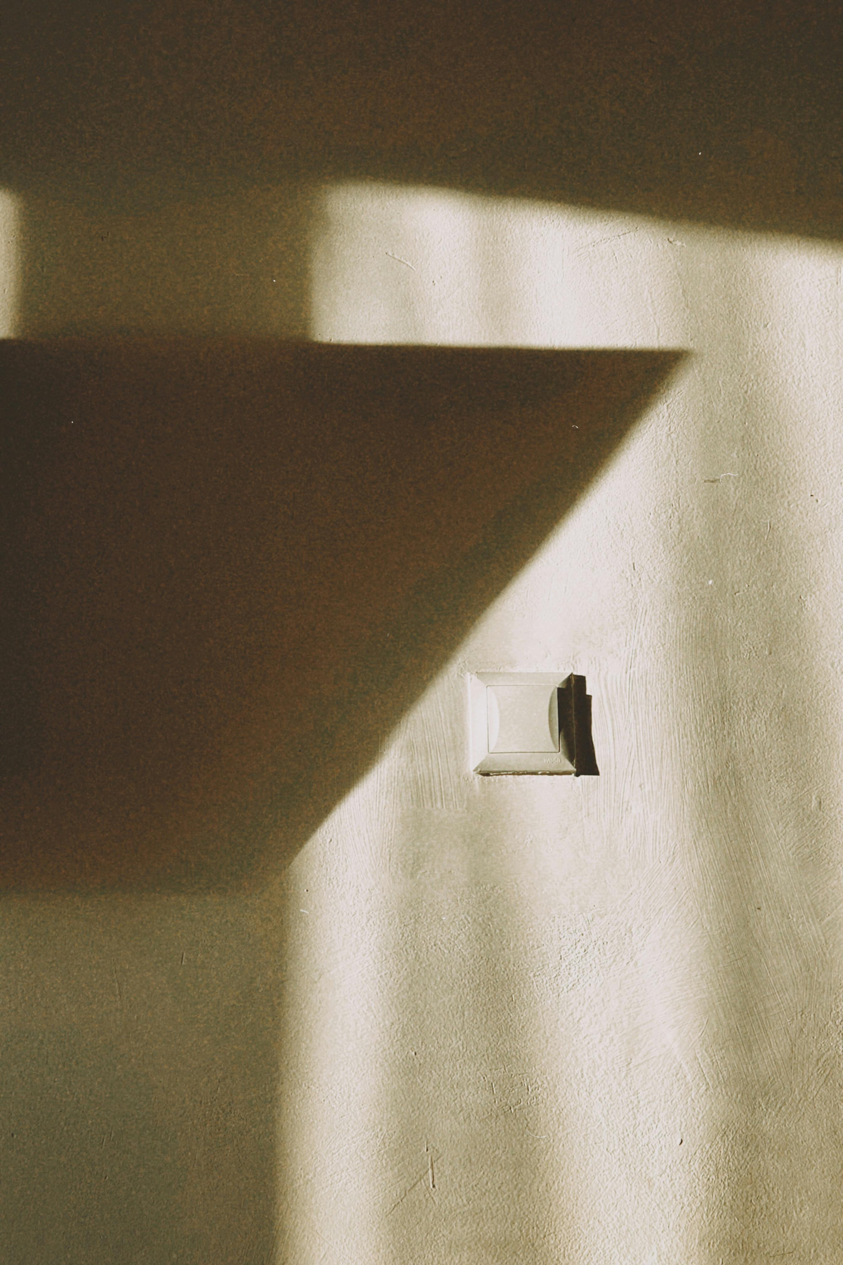 Unique abstract shadows cast on a textured wall in Talgar, Almaty Region.