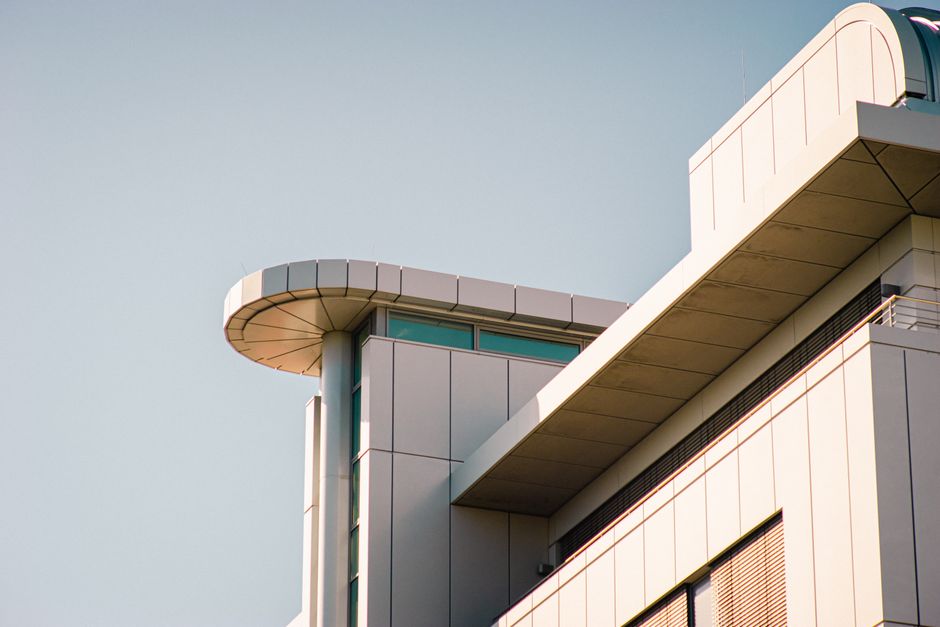 A contemporary building featuring geometric design elements under a clear sky, showcasing modern architecture.