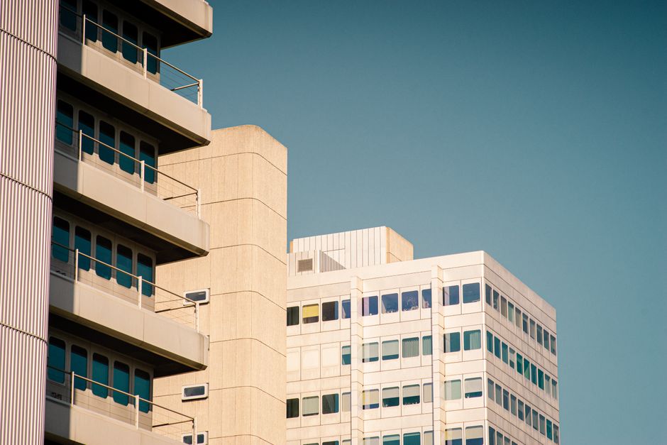 Close-up of modern urban architecture featuring prominent balconies under a clear sky.