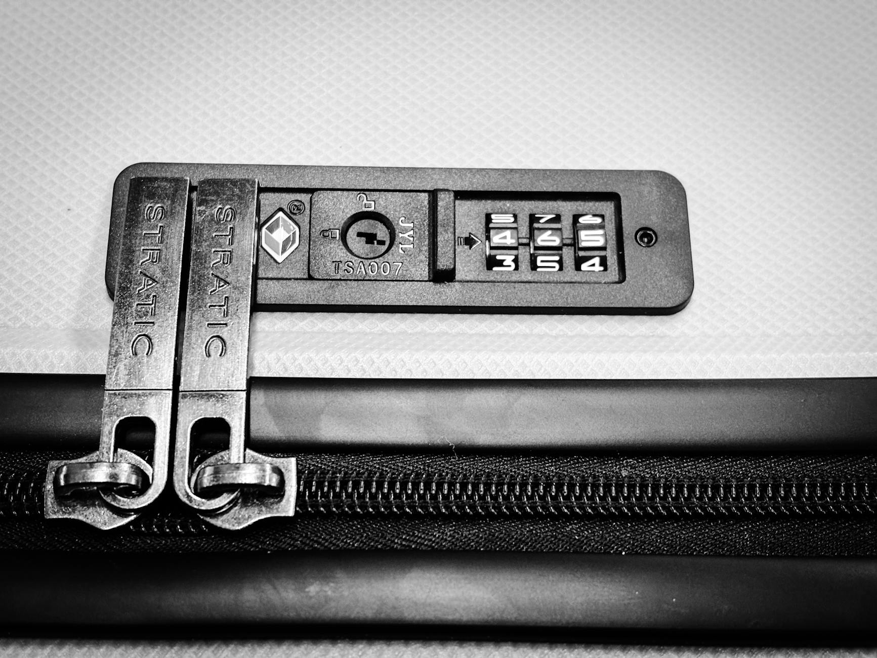 Close-up image of a TSA-compatible zipper lock on a suitcase, ensuring travel security.