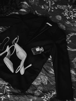 Stylish evening essentials arranged in a sophisticated monochrome composition.