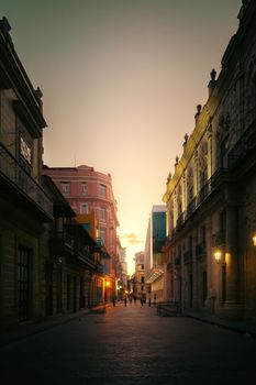 A beautiful alley in Havana at sunset, showcasing stunning architecture and ambient street lighting.