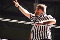 Referee in Action at Wrestling Match