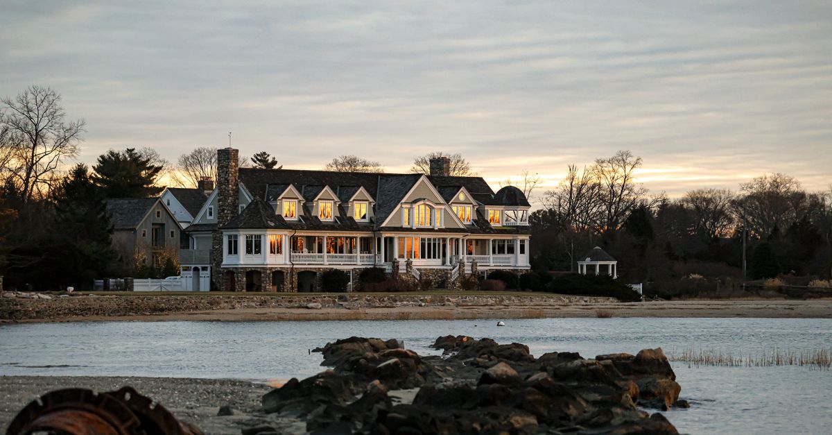 A beautiful waterfront estate in Stamford, Connecticut captured at twilight, reflecting a serene and elegant atmosphere.