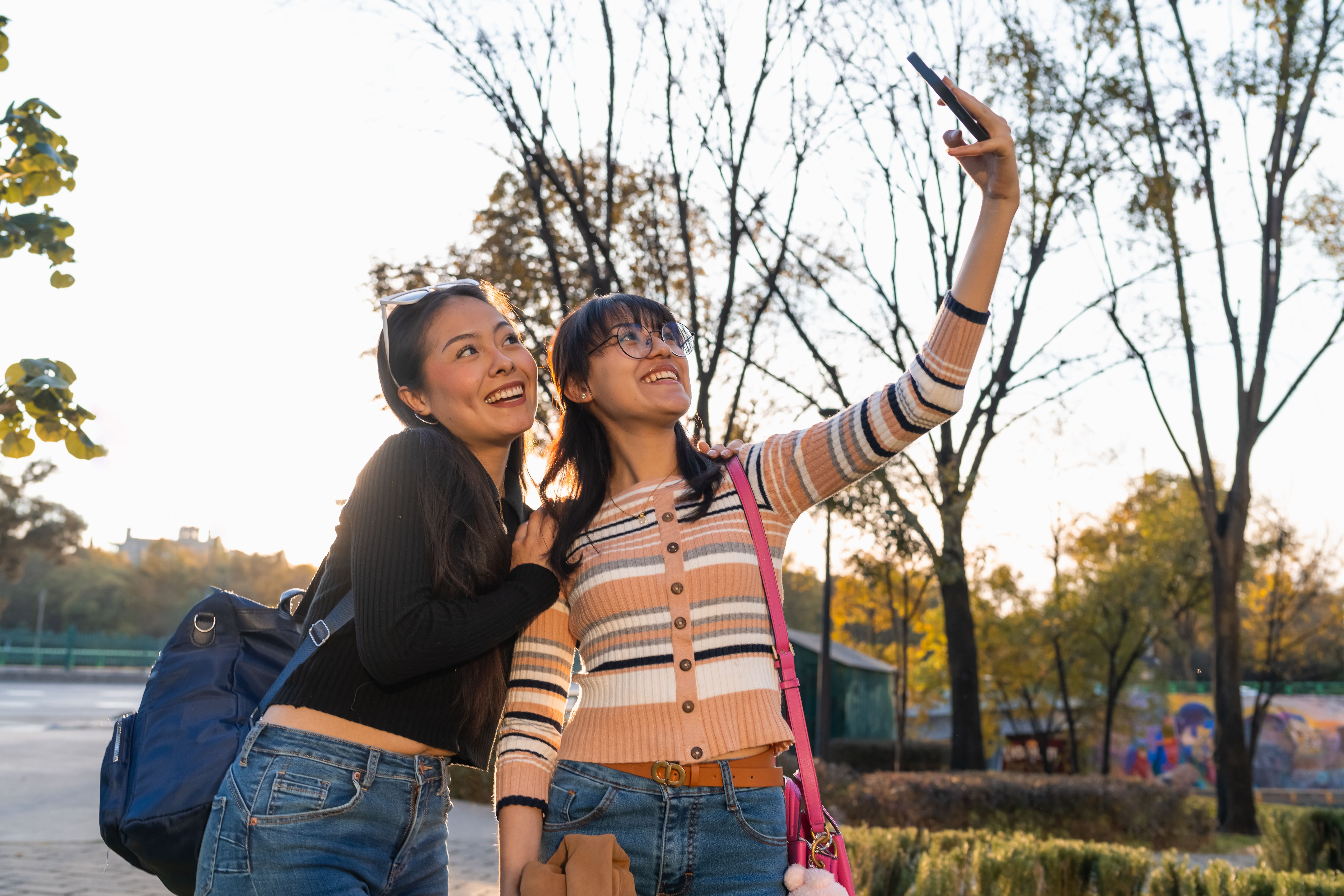 Colleagues capturing photos on a park scavenger hunt