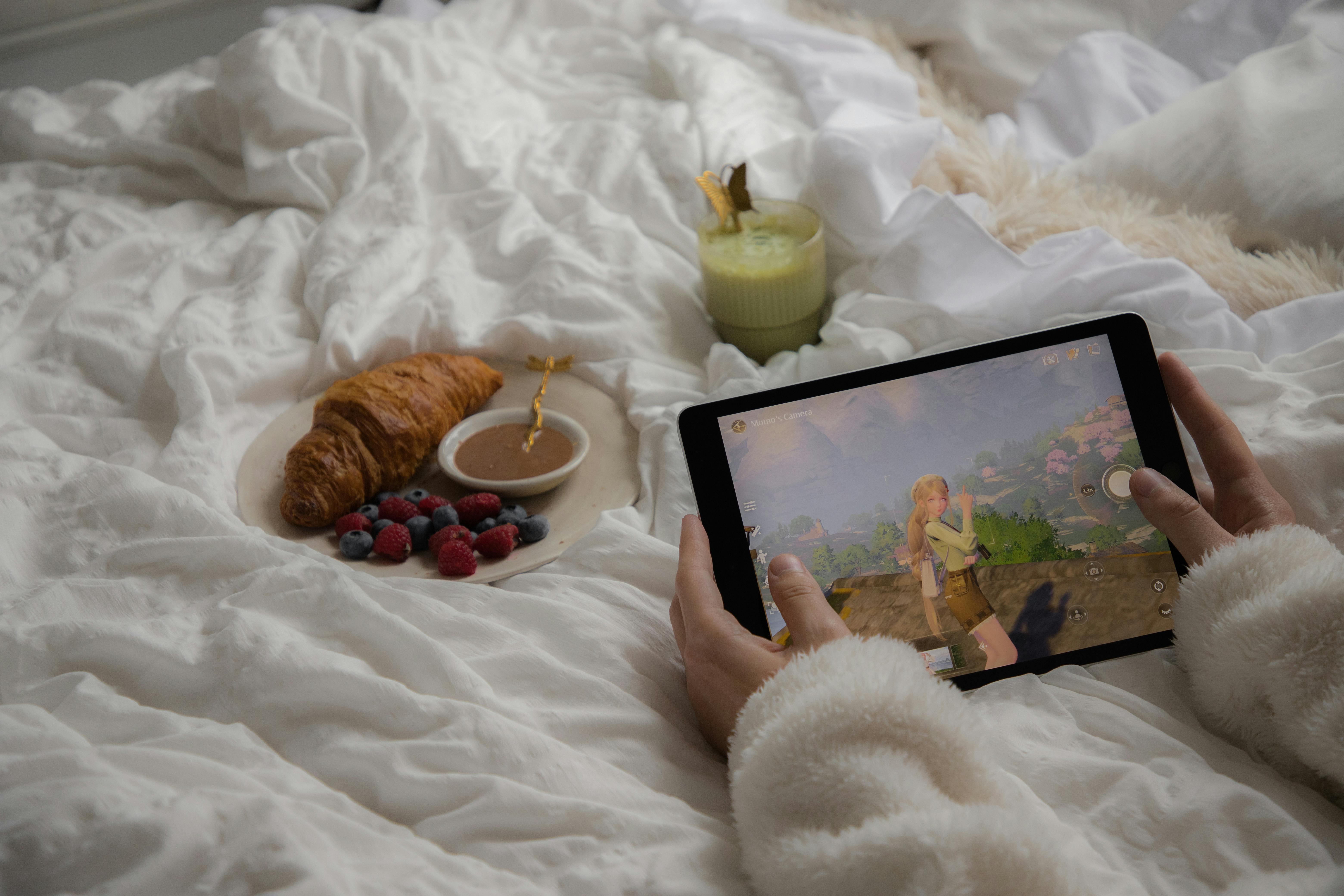 cozy morning with breakfast and gaming on tablet
