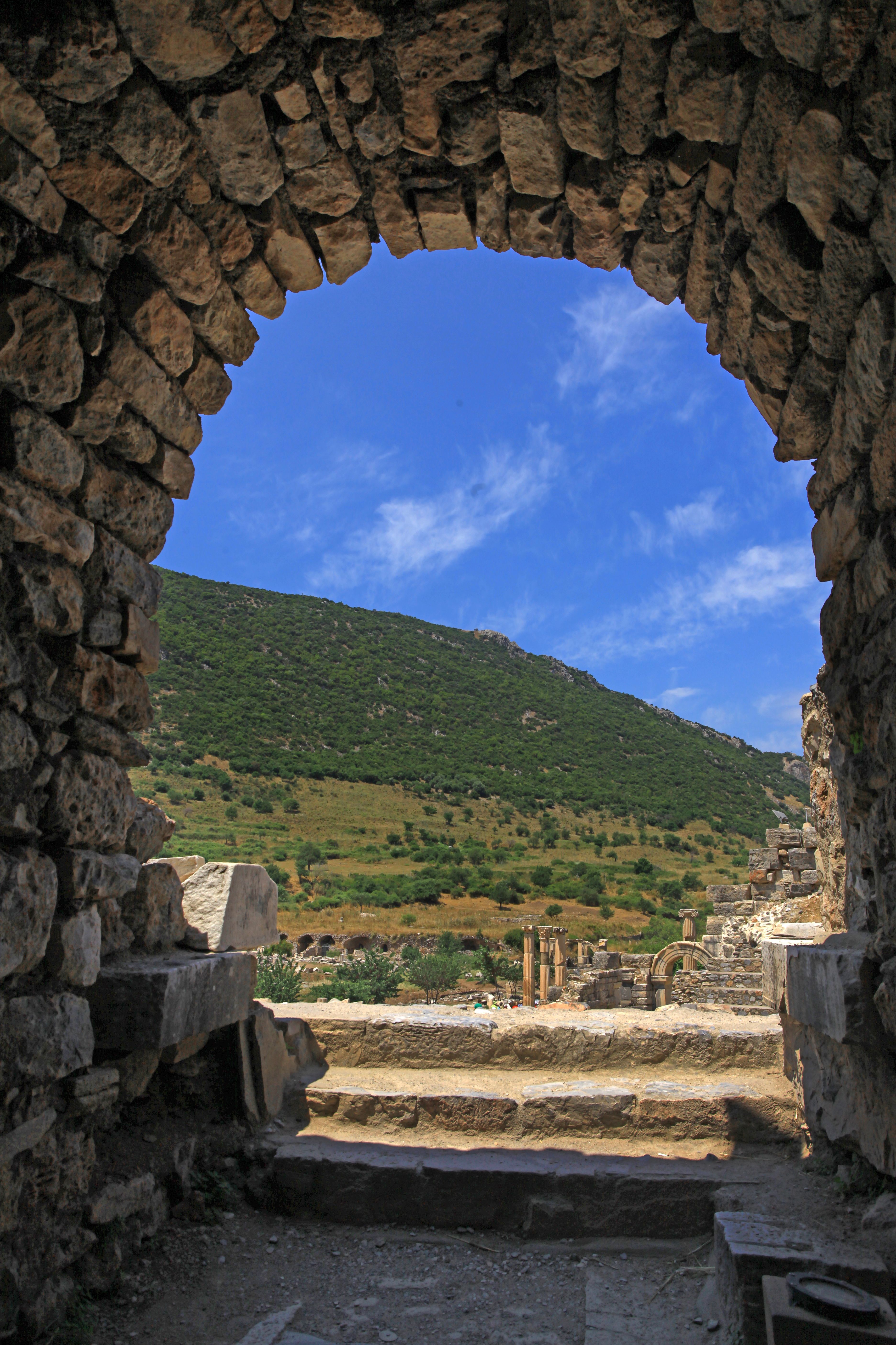 Ancient Stone Archway Overlooking Lush Landscape · Free Stock Photo