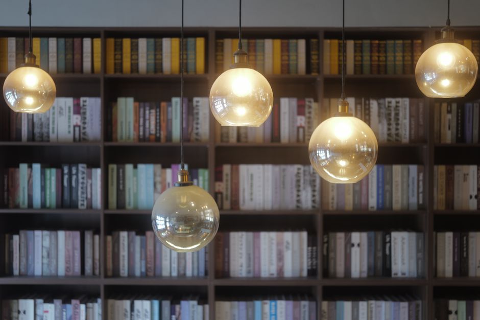 Warm ambient lighting in a home library with bookshelves.