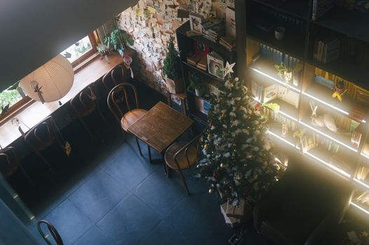 A warm and inviting cafe setting featuring a beautifully decorated Christmas tree.