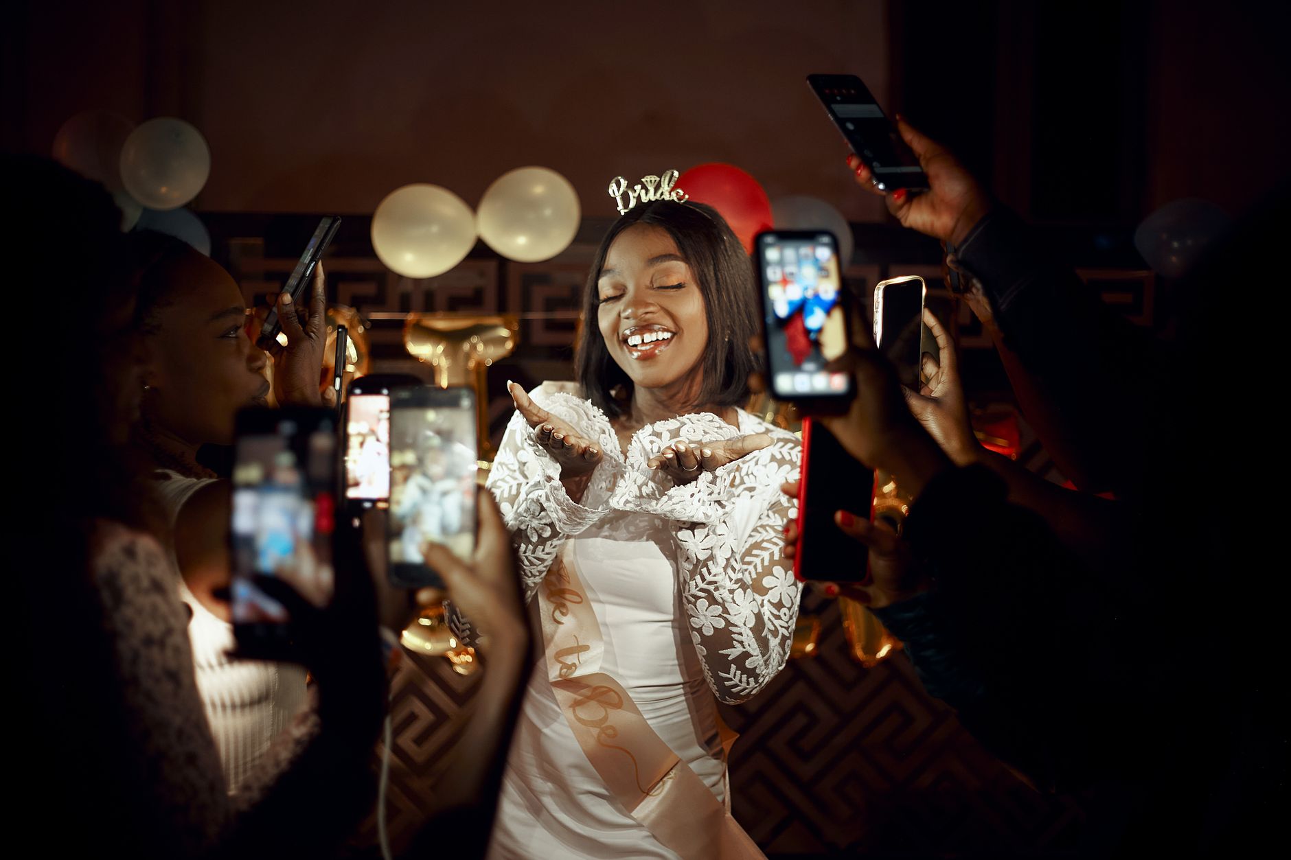 A bride-to-be at her bachelorette, friends already pulling out phones — the photo gallery building itself in real time