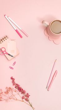Aesthetic pink office flat lay featuring stationery and coffee.