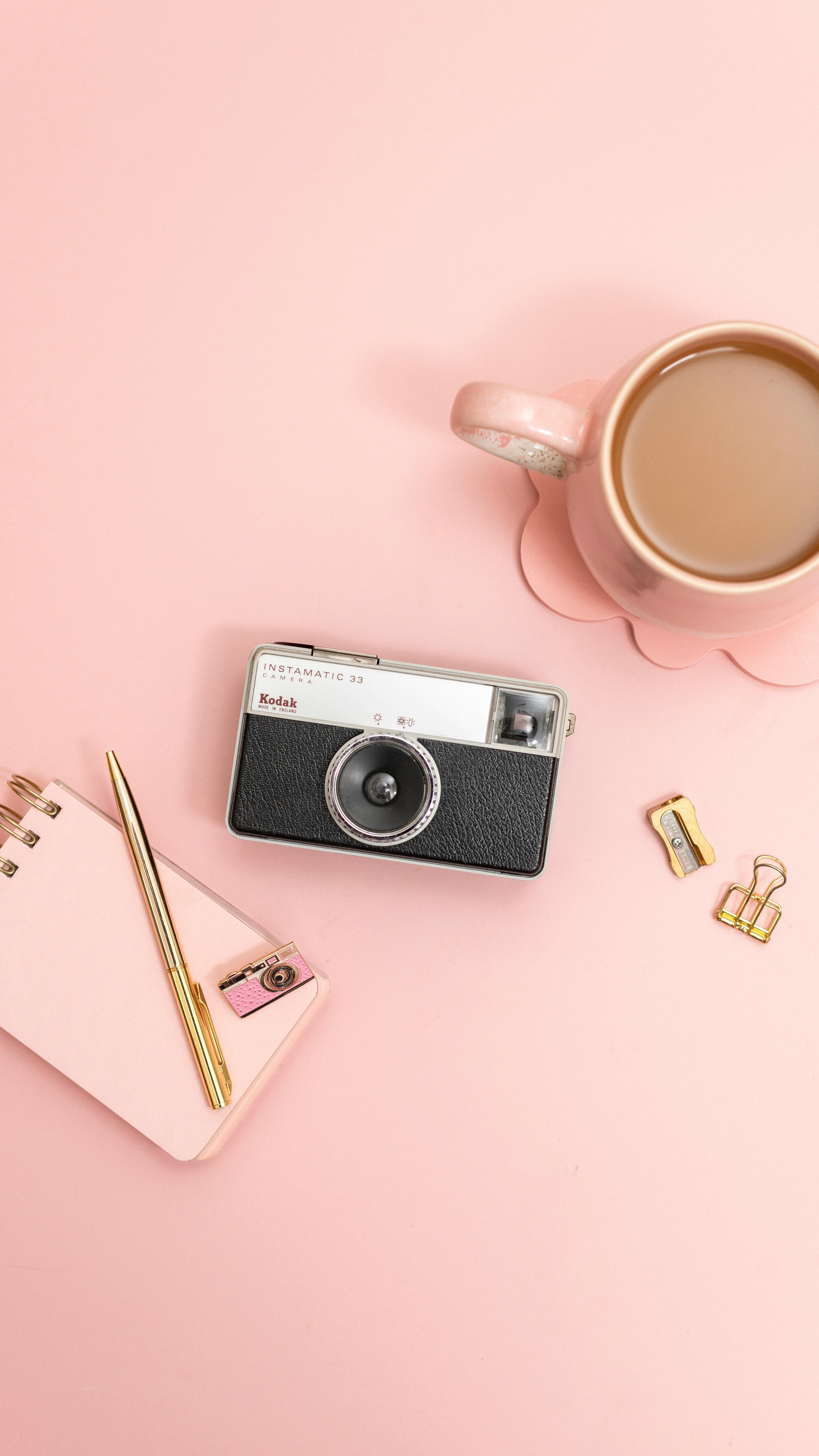 vintage camera and pink desk flat lay