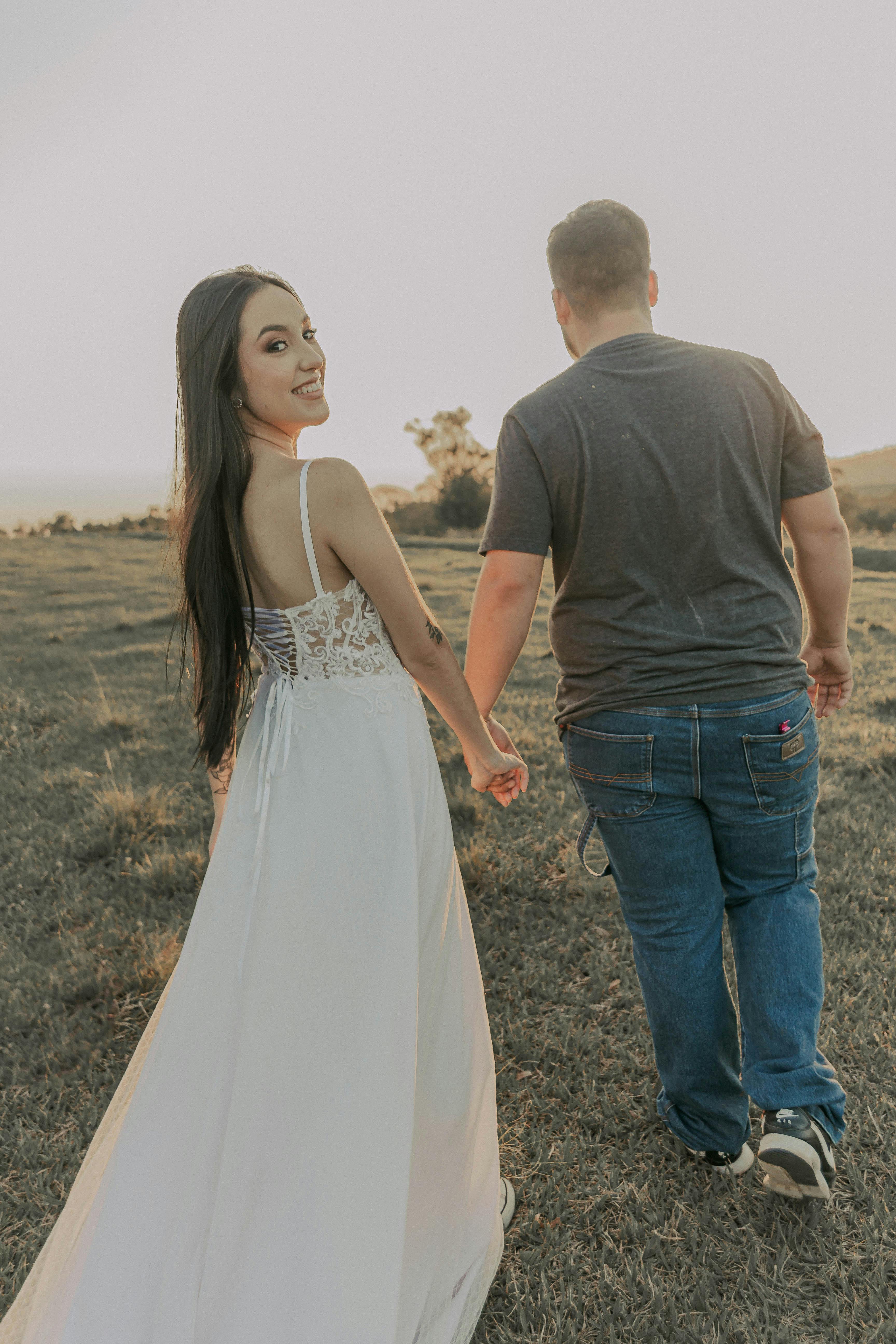 romantic couple walking hand in hand outdoors