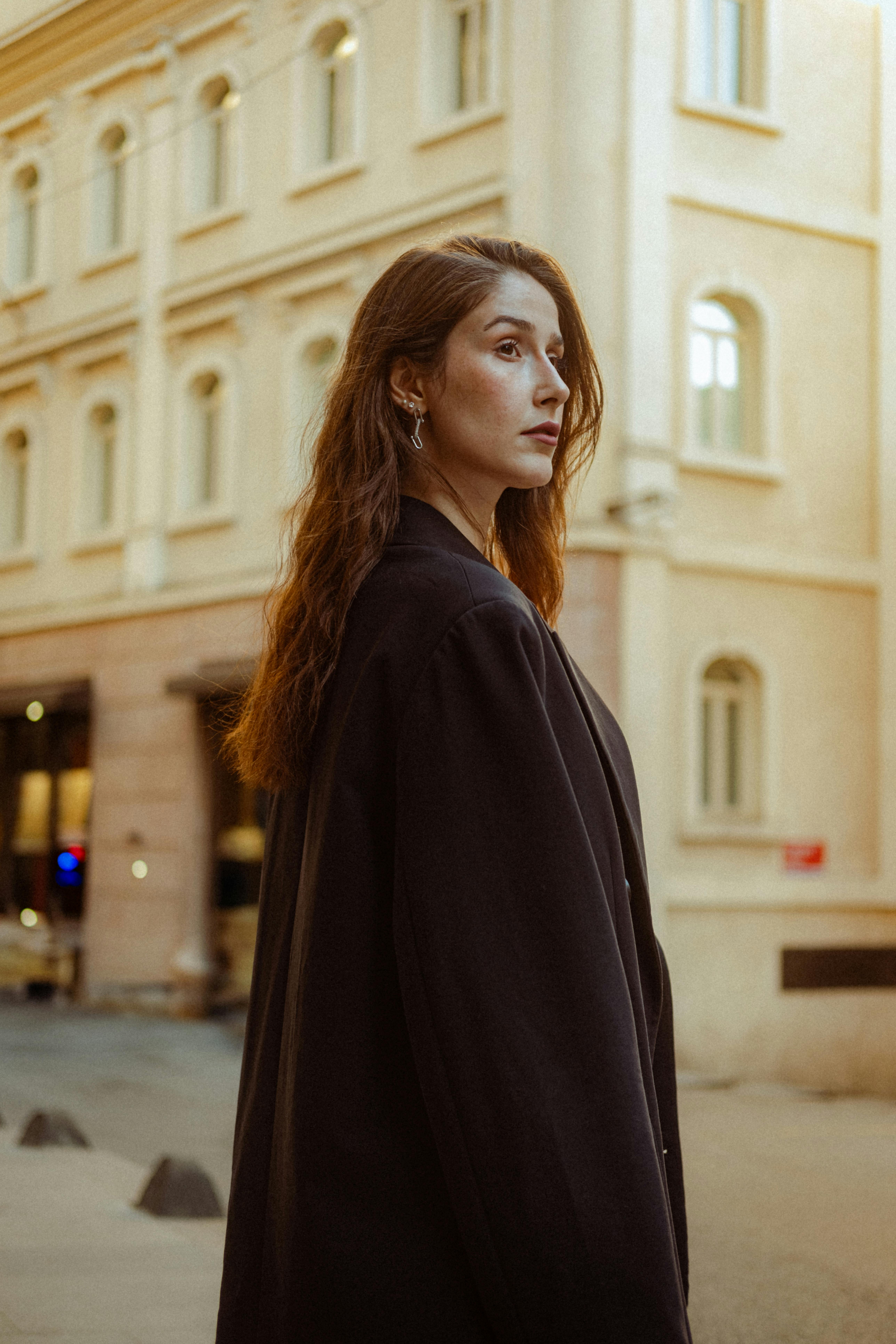 Portrait of a fashionable woman in a city street, showcasing urban style.